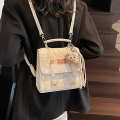On-model cream patchwork mini backpack with chain straps, rear view walking down stairs.