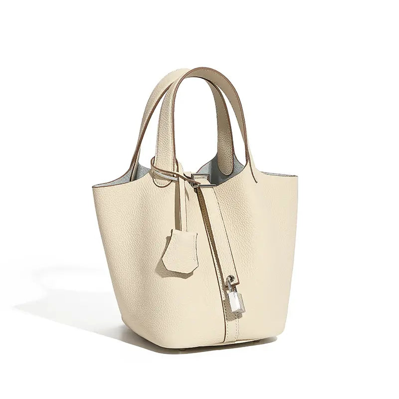 Classic Leather Bucket Bag in neutral tone, featuring a minimalist design with drawstring closure and top-handle.