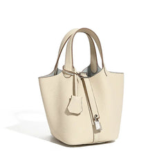 Classic Leather Bucket Bag in neutral tone, featuring a minimalist design with drawstring closure and top-handle.