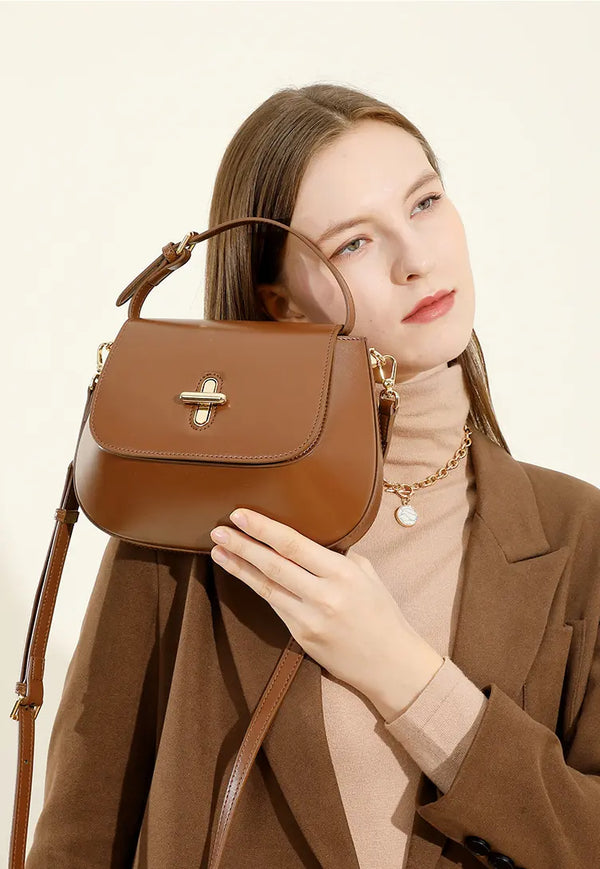 Model showcasing the Capsule Leather Crossbody bag with a sophisticated design and chic detailing.