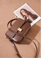 Minimalist Tofu Bag in brown leather with a gold clasp, perfect for everyday use as a stylish shoulder bag.
