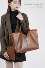 Large Leather Tote Bag carried by a model, showcasing its sleek design and rich brown color, perfect for everyday use.