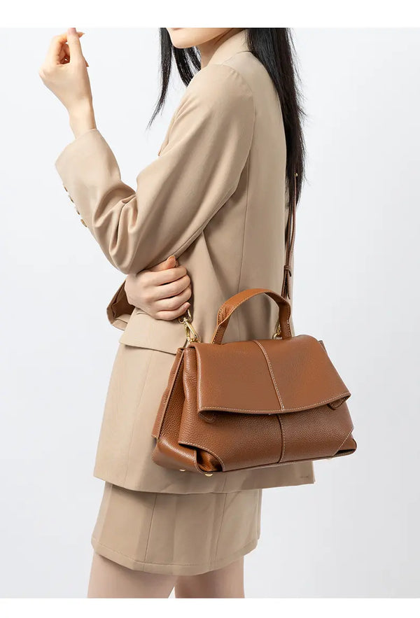 Premium Leather Crossbody Bag in golden brown, styled for urban minimalist look, perfect for casual everyday use.