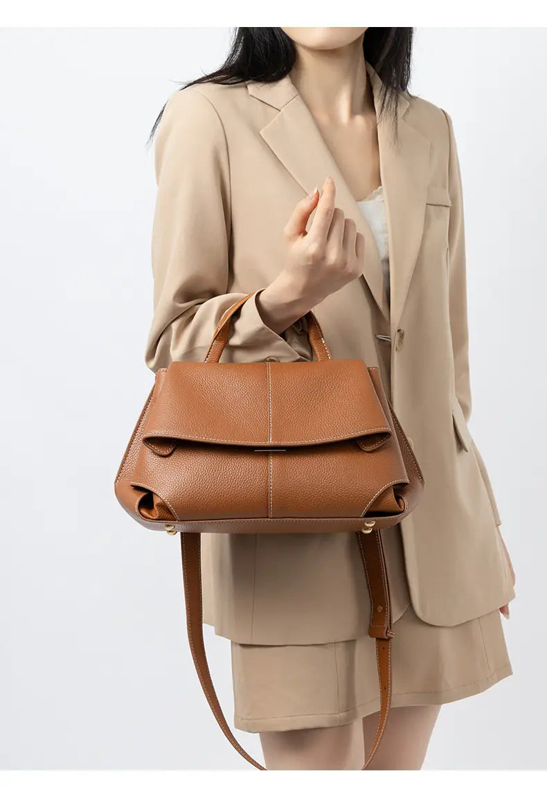 Premium Leather Crossbody Bag in gold brown, showcasing minimalist design and flap closure, perfect for everyday use.