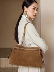Model showcasing the Suede Leather Baguette Shoulder Bag in brown, paired with a stylish outfit and accessories.