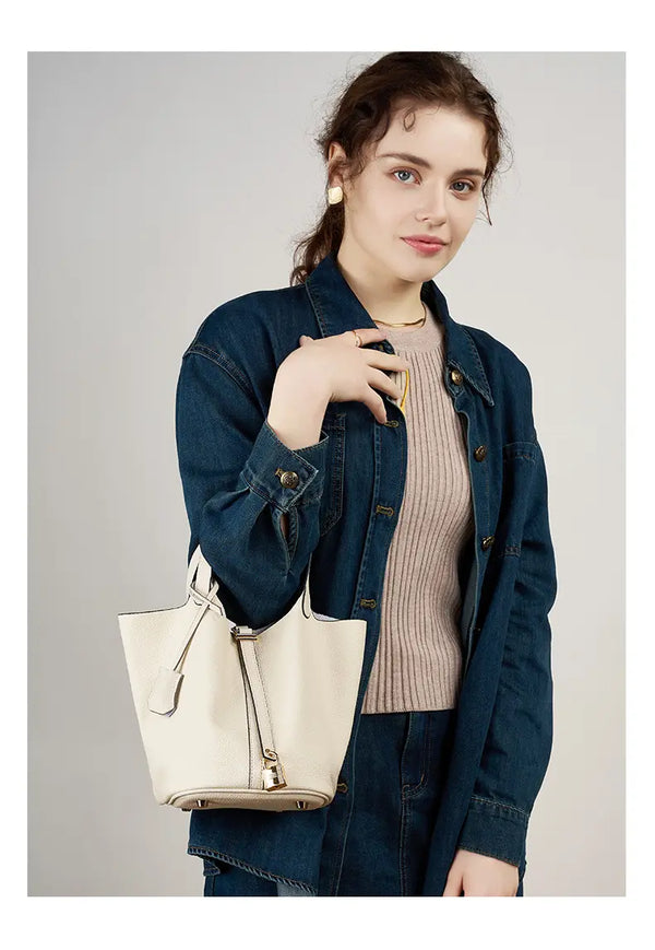 Classic Leather Bucket Bag worn in studio shot, showcasing women's bucket bag with neutral tone and minimalist style.