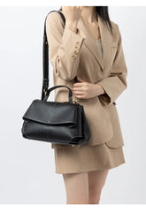 Premium Leather Crossbody Bag in black, styled with a blazer, showcasing an urban minimalist fashion aesthetic.
