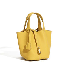 Classic Leather Bucket Bag in vibrant yellow with top-handle, drawstring, and minimalist design for everyday style.