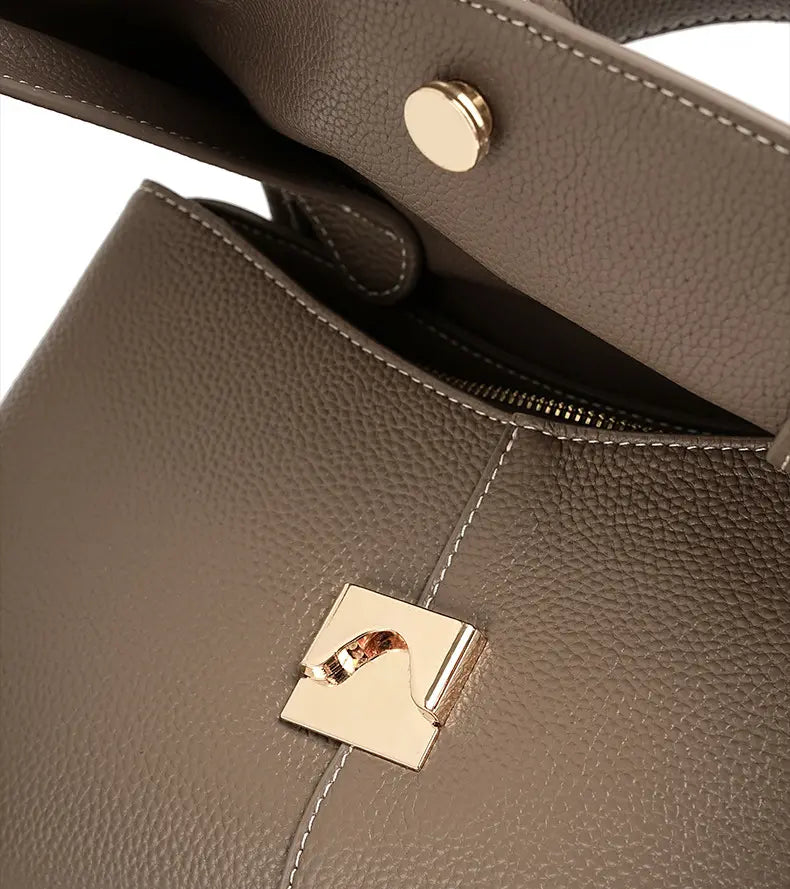 Premium Leather Crossbody Bag flap closure and gold hardware detail on khaki leather exterior.