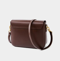 Minimalist Tofu Bag in dark brown leather with adjustable strap, perfect for everyday use and casual outings.