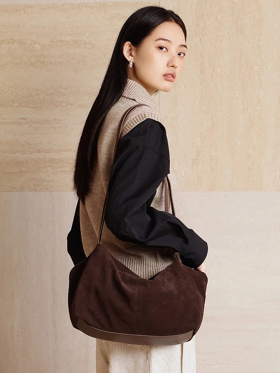 Stylish model showcasing Suede Leather Pillow Hobo Bag in dark brown, perfect for everyday use and vintage-inspired fashion.