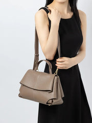 Premium Leather Crossbody Bag in khaki color, stylishly worn as a shoulder bag by a model.