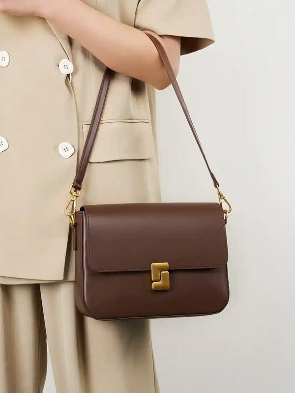 Minimalist Tofu Bag in brown leather with adjustable strap, featuring flap and magnetic closure, perfect for casual or work use.
