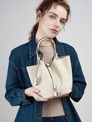 Model showcasing the Classic Leather Bucket Bag in a minimalist neutral tone with a studio shot.