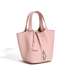 Classic Leather Bucket Bag in soft pink with top-handle and drawstring, perfect for everyday style.