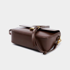 Minimalist Tofu Bag made from genuine leather, featuring an adjustable strap and magnetic closure in brown.