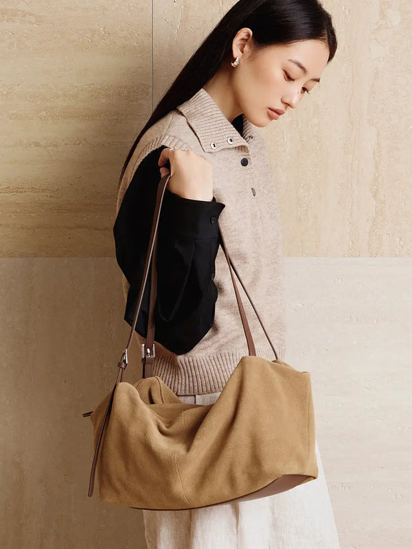 Suede Leather Pillow Hobo Bag displayed on a model wearing a stylish outfit, showcasing its vintage-inspired design.