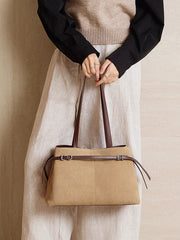 Suede Leather Baguette Shoulder Bag being held, stylish beige tote bag with adjustable straps.