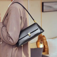 European Retro Shoulder Bag in black leather with adjustable strap, worn casually, showcasing vintage-inspired elegance.