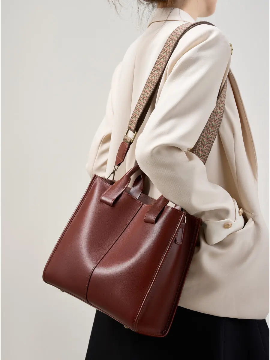 Top-Handle Leather Tote in rich burgundy, styled with a patterned adjustable strap, perfect for work or casual outings.