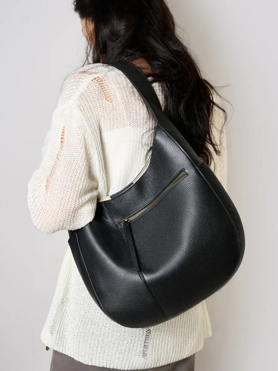 Leather Crescent Hobo Bag in black, worn over the shoulder, showcasing its stylish design.