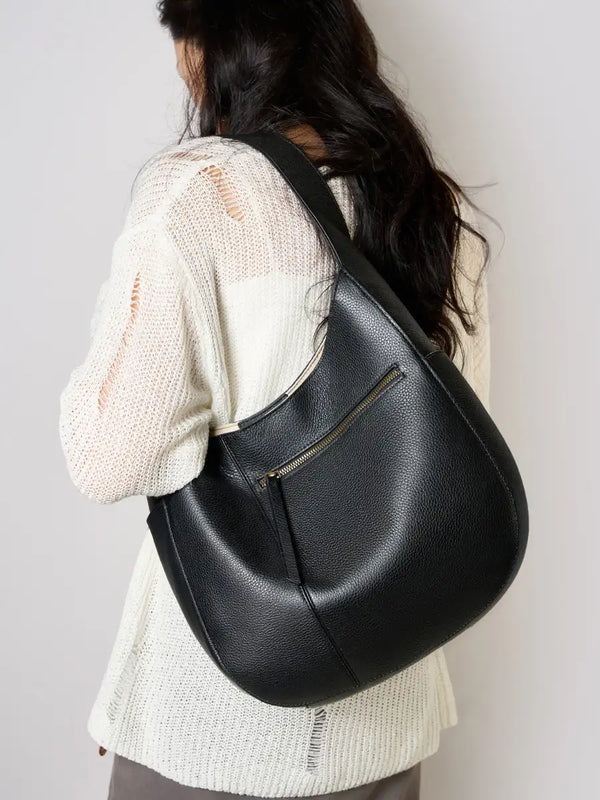 Leather Crescent Hobo Bag in black, worn over the shoulder, showcasing its stylish design.