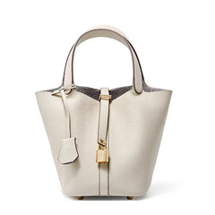 Classic Leather Bucket Bag in neutral tone with minimalist design, featuring drawstring and top-handle for everyday style.