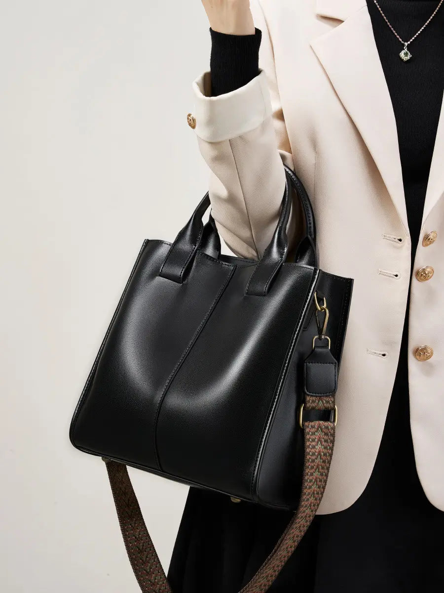 Top-Handle Leather Tote displayed with top handles and an adjustable strap, perfect for everyday and work use.