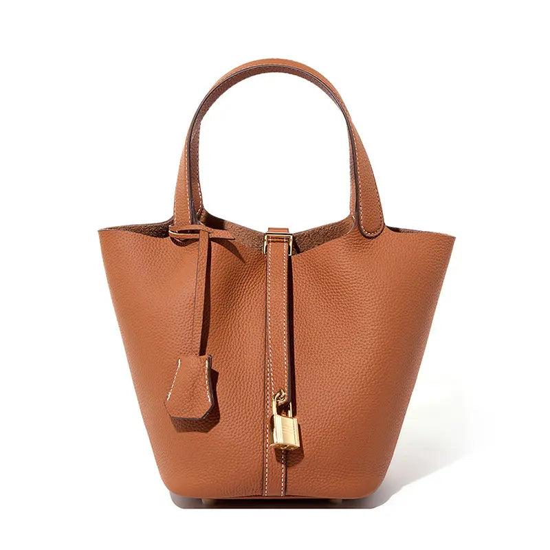 Classic Leather Bucket Bag in a neutral tone, minimalist design with top-handle and drawstring detail.
