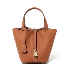 Classic Leather Bucket Bag in a neutral tone, minimalist design with top-handle and drawstring detail.