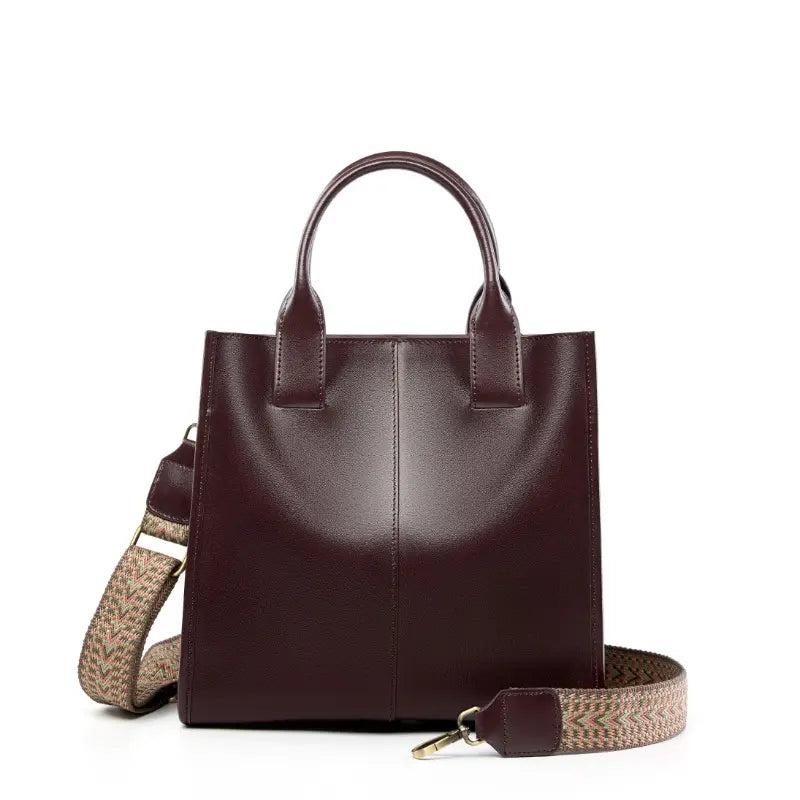 Top-Handle Leather Tote in dark burgundy with adjustable strap and minimalist design for everyday use.