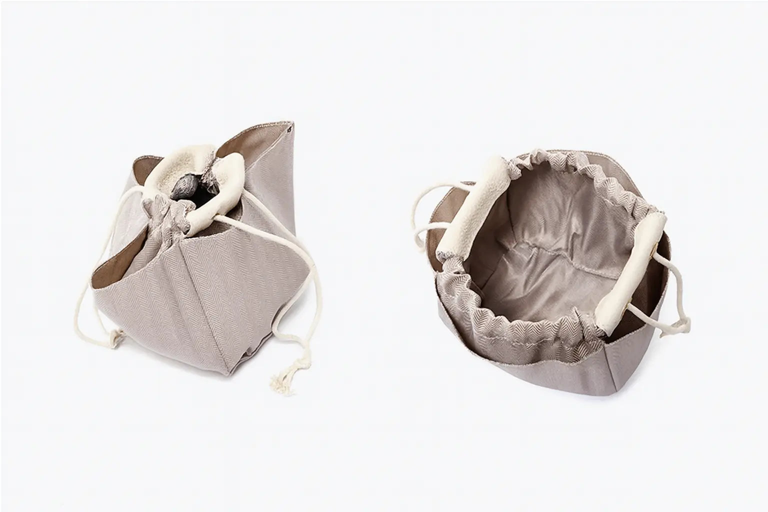 Classic Leather Bucket Bag in neutral tone, featuring top-handle and drawstring design, showcasing minimalist style.