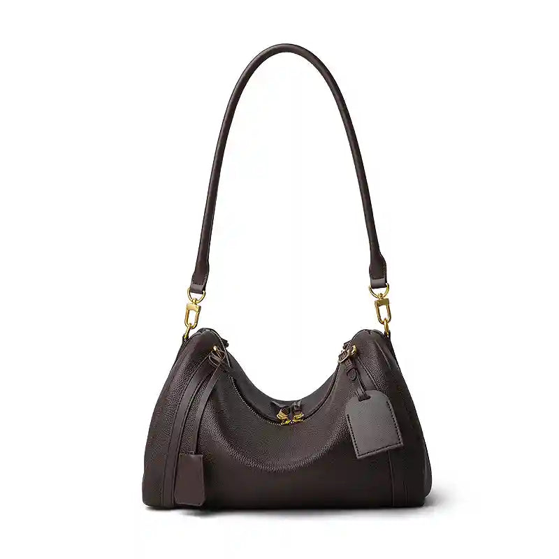 Suede Crescent Shoulder Bag showcasing a vintage-inspired design with a hobo bag silhouette and metal ring details.