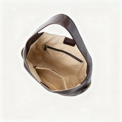 Interior view of Leather Crescent Hobo Bag showcasing pockets and lining in a spacious shell shape design.