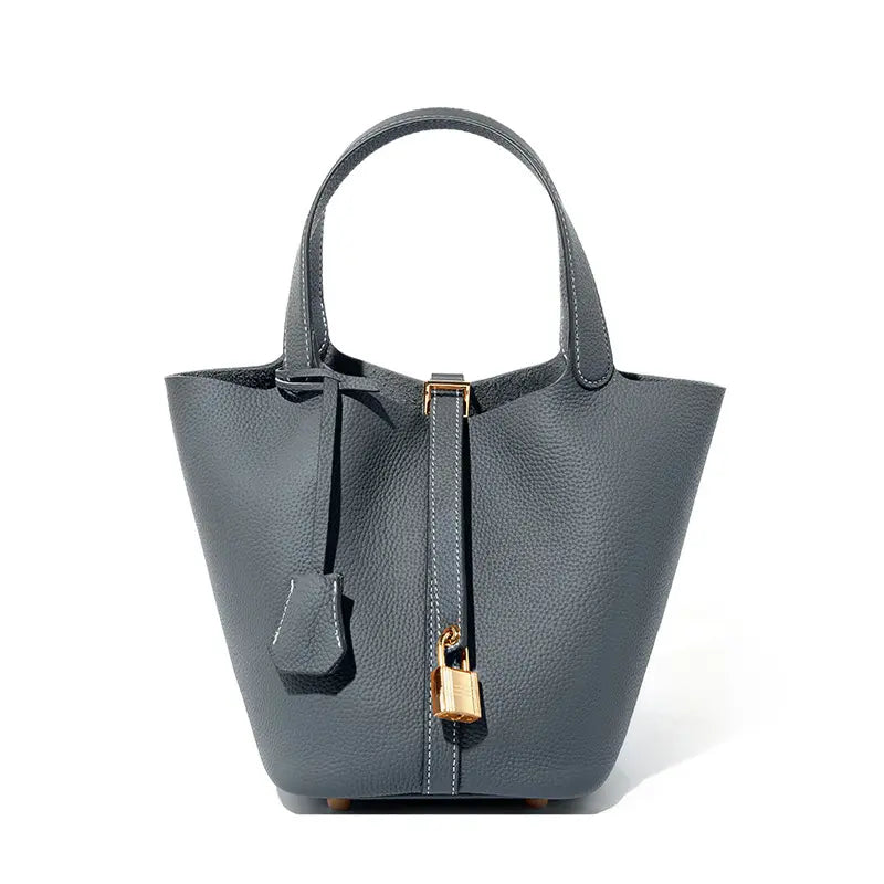 Classic Leather Bucket Bag in chic gray color, showcasing the minimalist design with top-handle and drawstring.